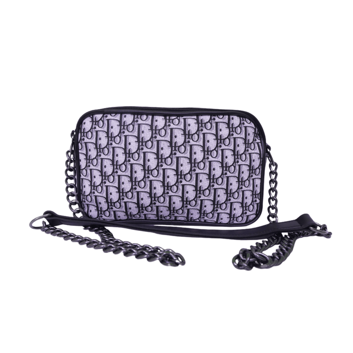 Luxury inspired Antaaj crossbody bag with faux feather material, long chain strap, and dual zipper compartments.